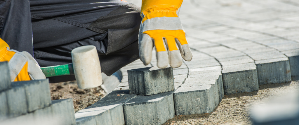 Expert driveway paving North York. Workers laying interlocking pavers for a custom-designed driveway.